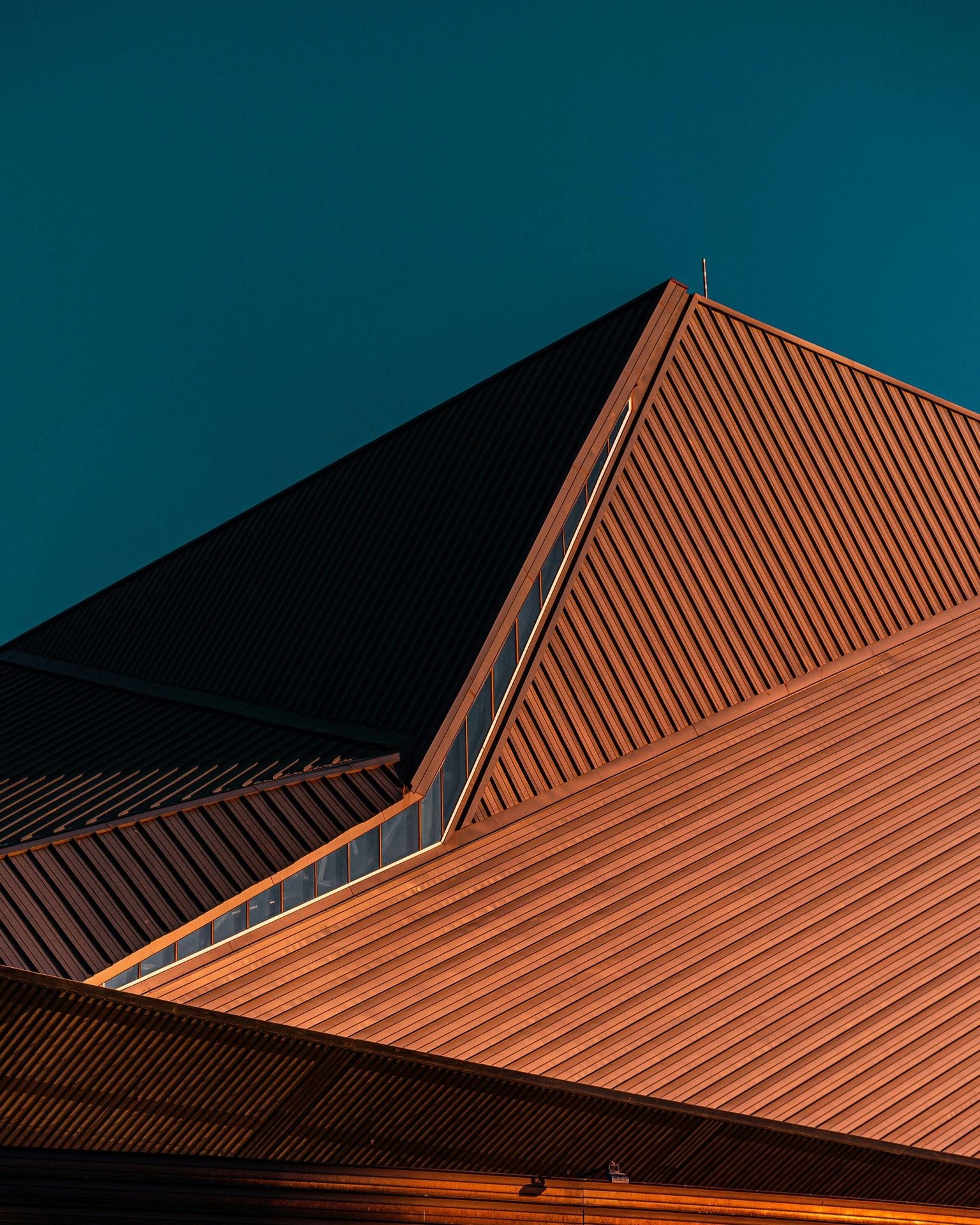 For strategic IP management choose Questel IP software solutions, image of orange building against blue sky