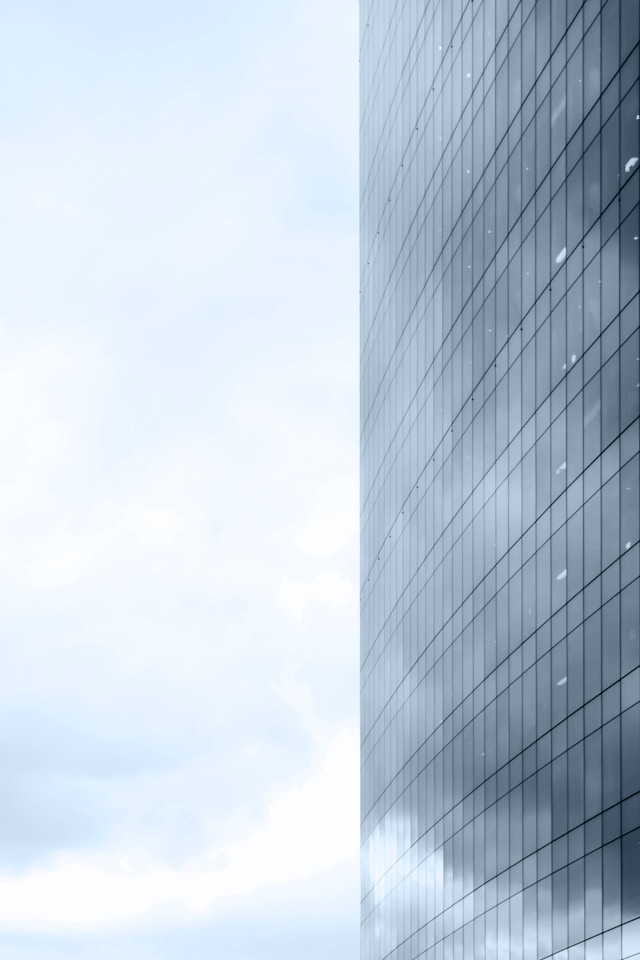 Tips for in-house legal department, image of tall building, cloudy sky