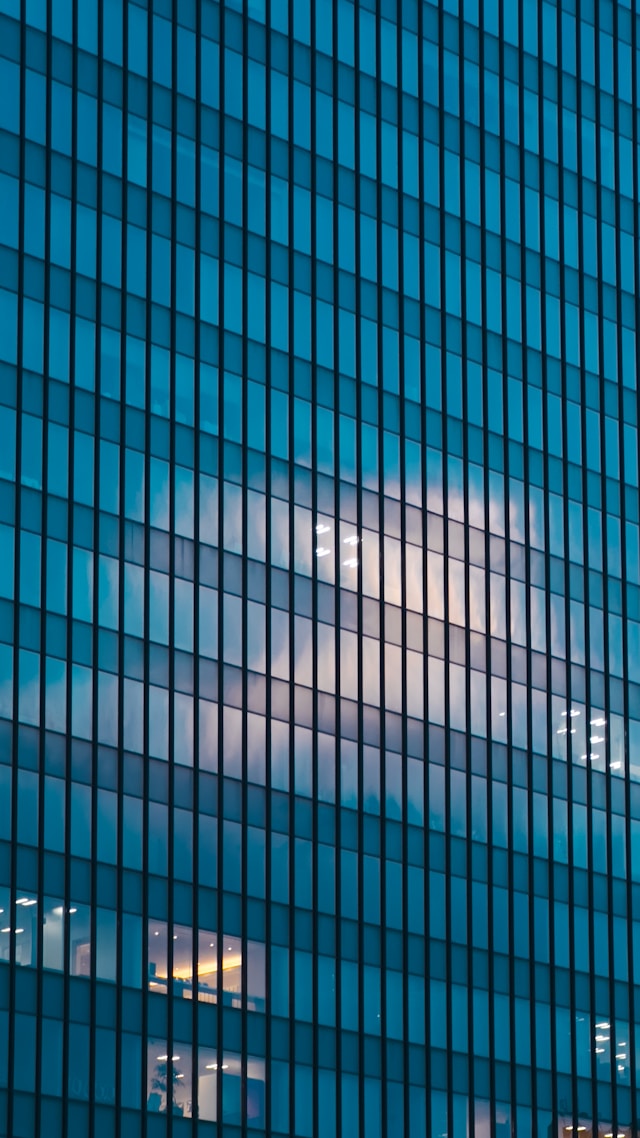 Patent renewals management, easy, image of sunlight reflecting on blue building
