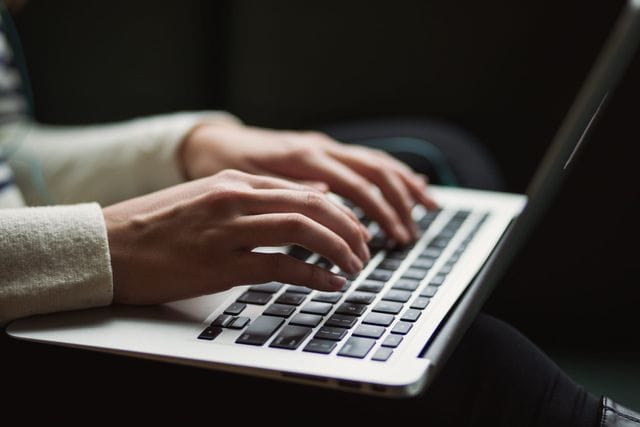 Innovation management solutions person working on laptop