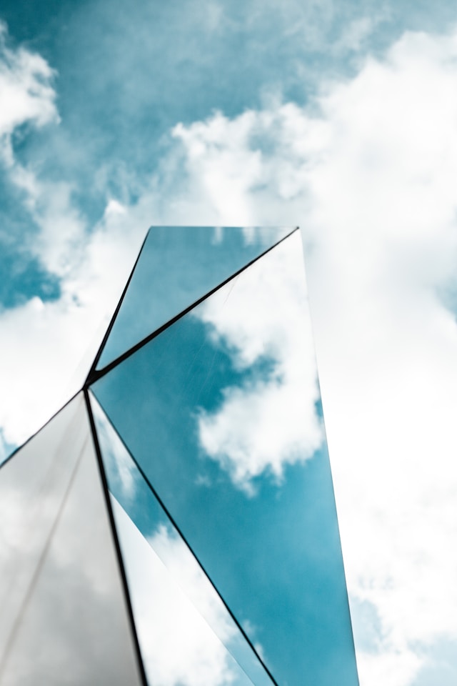 Patent use case, foreign filing costs, translation costs, image of blue sky reflecting on glass building