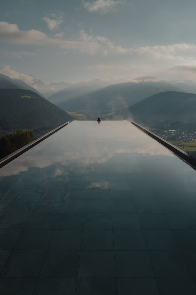 Why do companies choose to outsource work, image of scenic pool